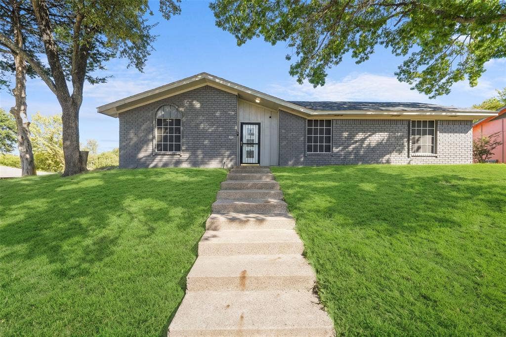6606 Coleshire Drive, Dallas, TX 75232 Brick exterior featuring a gabled roofline and arched window