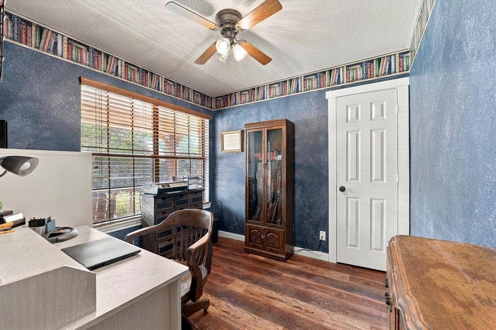 1600 Fox Ridge Road, Lorena, TX 76655 Wood-finish flooring, multi-panel interior door, ceiling fan with integrated lighting, and horizontal slatted window blinds