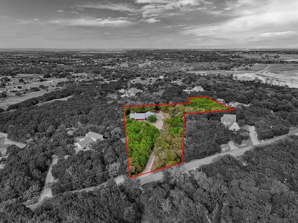 1600 Fox Ridge Road, Lorena, TX 76655 Aerial perspective of expansive acreage featuring dense mature tree coverage and a private driveway