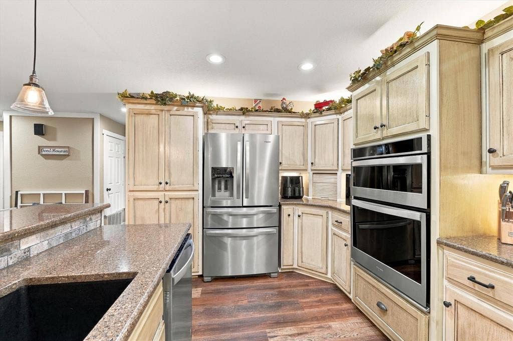 1600 Fox Ridge Road, Lorena, TX 76655 Kitchen featuring light-toned cabinetry, stainless steel double wall ovens, a multi-door refrigerator, stone-finish countertops, and wood-finish flooring