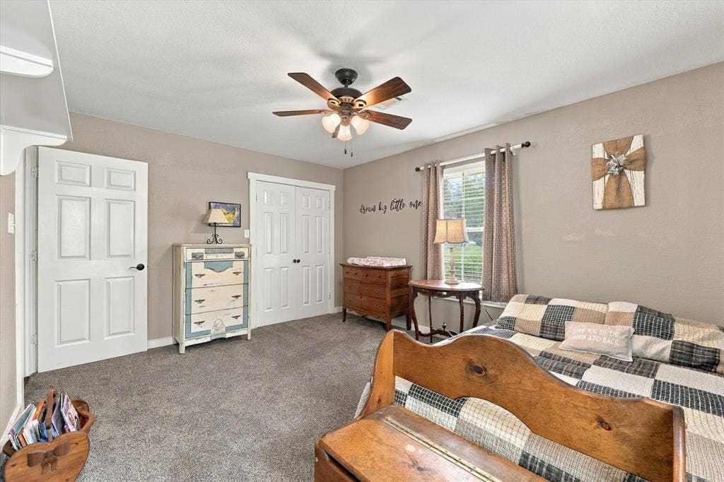 1600 Fox Ridge Road, Lorena, TX 76655 Room featuring neutral wall tones, wall-to-wall carpeting, a multi-light ceiling fan, and dual-panel closet doors