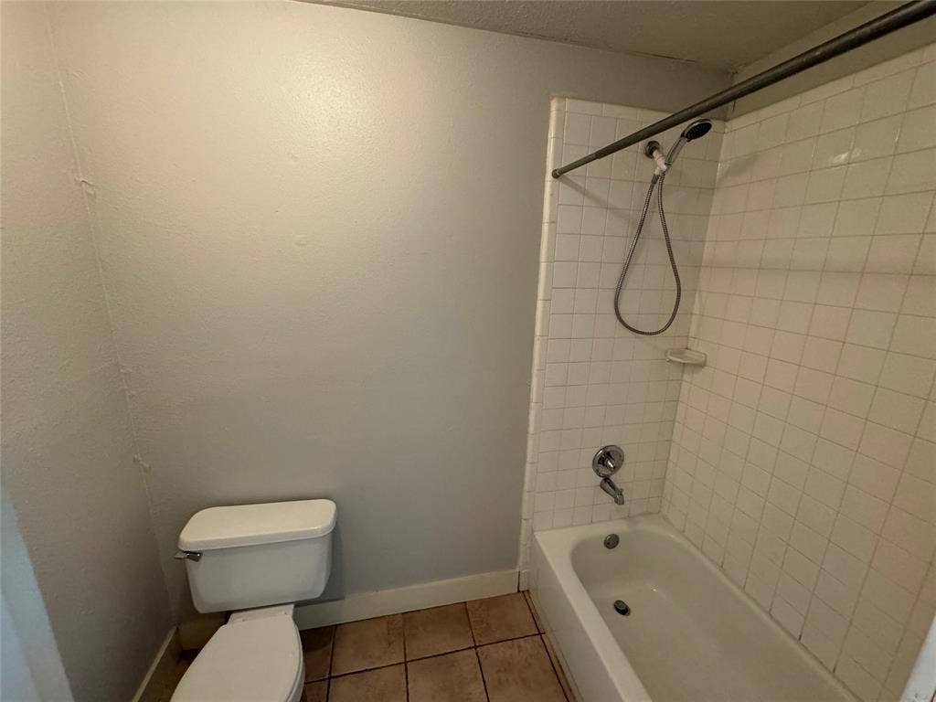 5321 Reiger Avenue, #4, Dallas, TX 75214 Bathroom featuring tiled shower / bath, toilet, and tile patterned floors