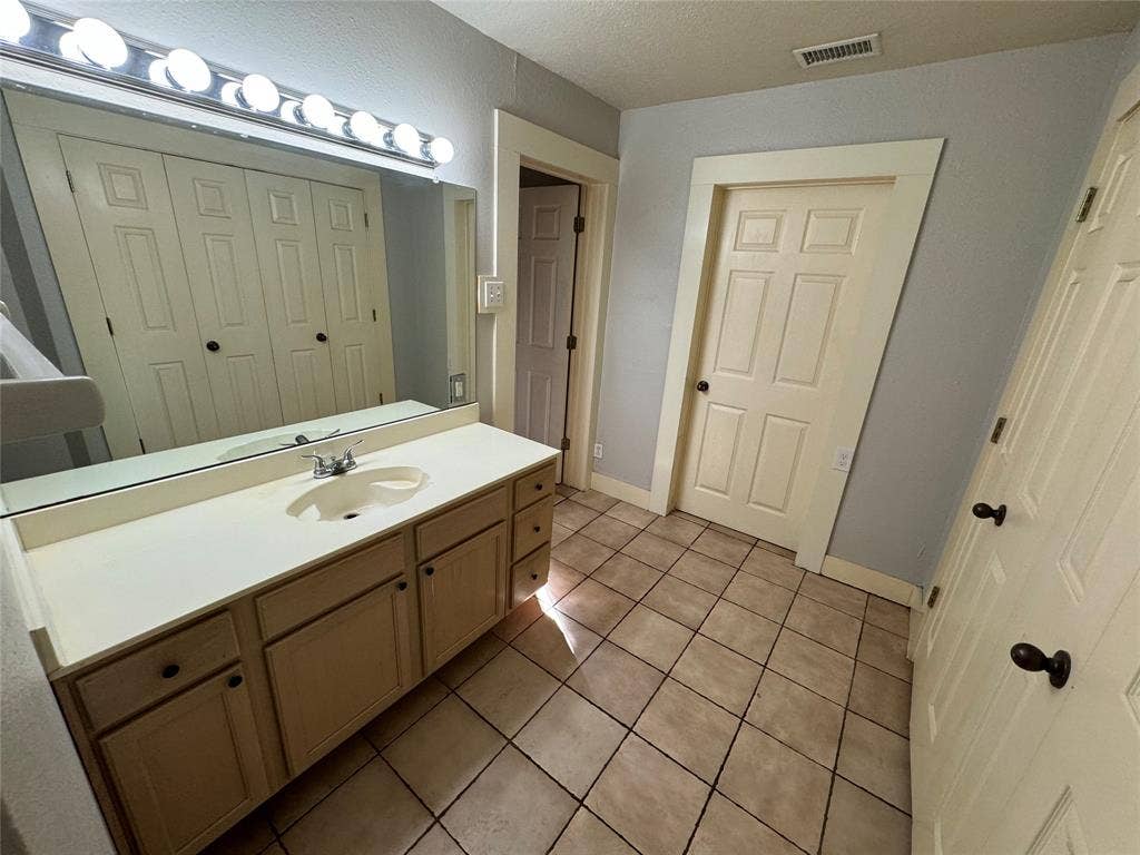 5321 Reiger Avenue, #4, Dallas, TX 75214 Bathroom with vanity, a textured ceiling, and tile patterned flooring