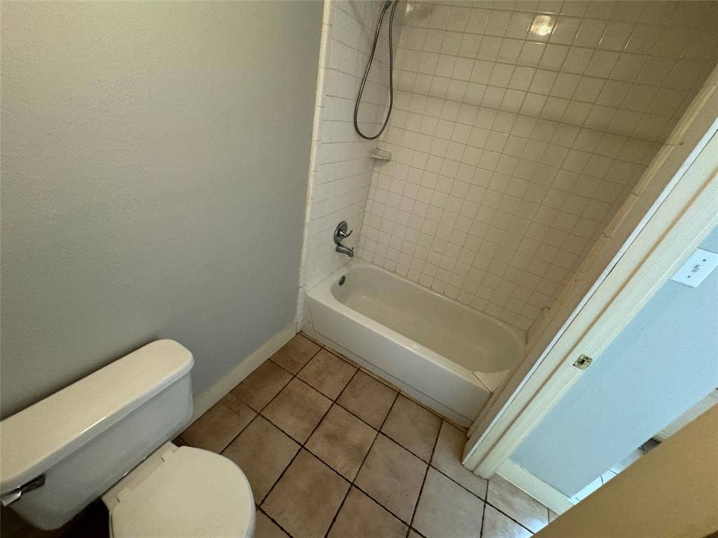 5321 Reiger Avenue, #4, Dallas, TX 75214 Bathroom featuring tiled shower / bath, toilet, and tile patterned flooring