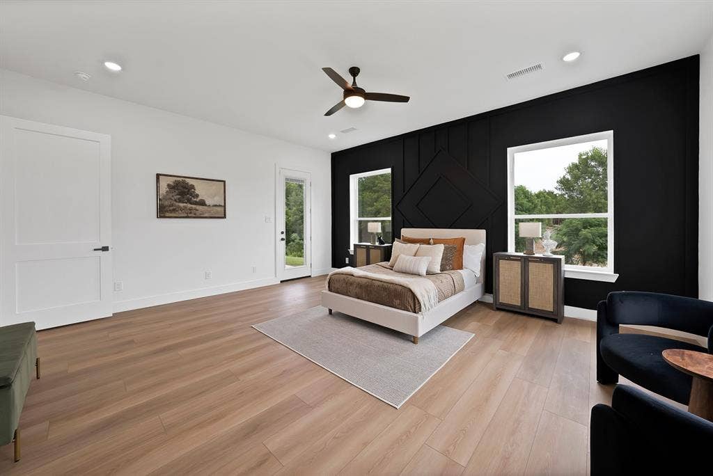 Expansive wood-finish flooring, recessed lighting, and a ceiling fan
