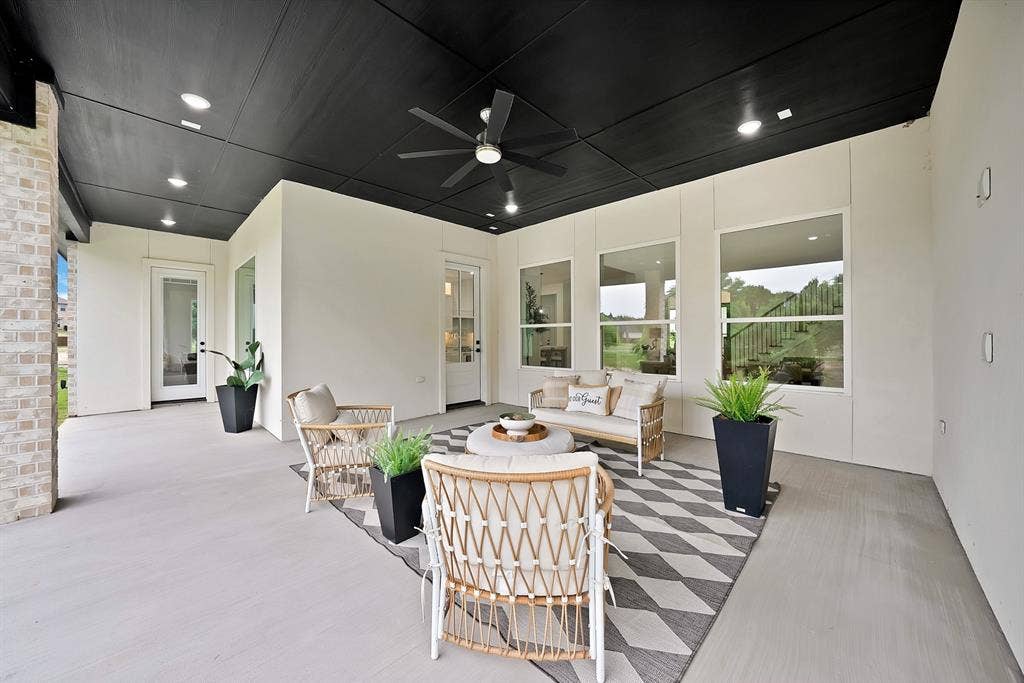 Covered patio featuring a black ceiling, recessed lighting, and a ceiling fan