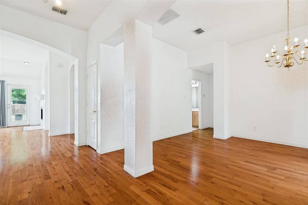 1412 Sleepy Hollow Drive, Allen, TX 75002 Hardwood flooring throughout, featuring a classic chandelier, recessed lighting, and a white paneled door