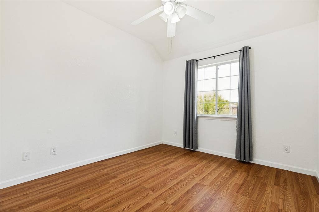 1412 Sleepy Hollow Drive, Allen, TX 75002 Vaulted ceiling, wood-finish flooring, white walls, ceiling fan, and a multi-pane window