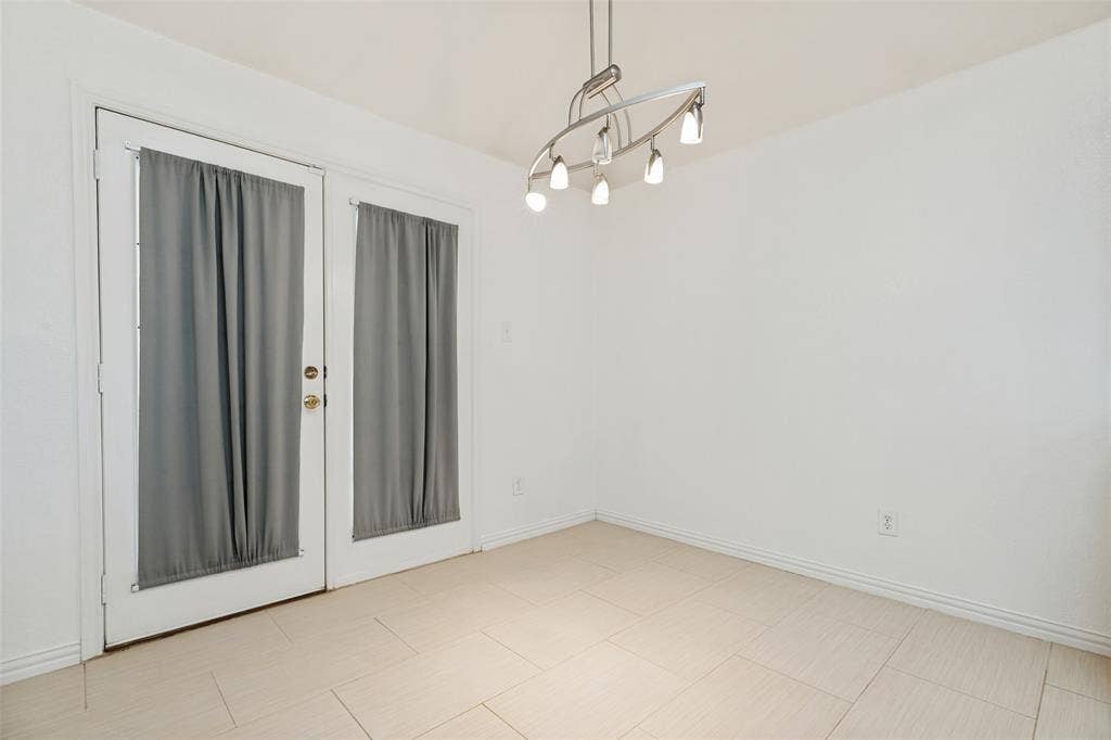 1412 Sleepy Hollow Drive, Allen, TX 75002 White walls featuring a contemporary linear chandelier and light-toned tile flooring