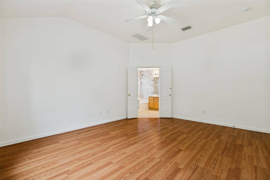 1412 Sleepy Hollow Drive, Allen, TX 75002 Vaulted ceiling with a ceiling fan, wood-finish flooring, and double-door entry