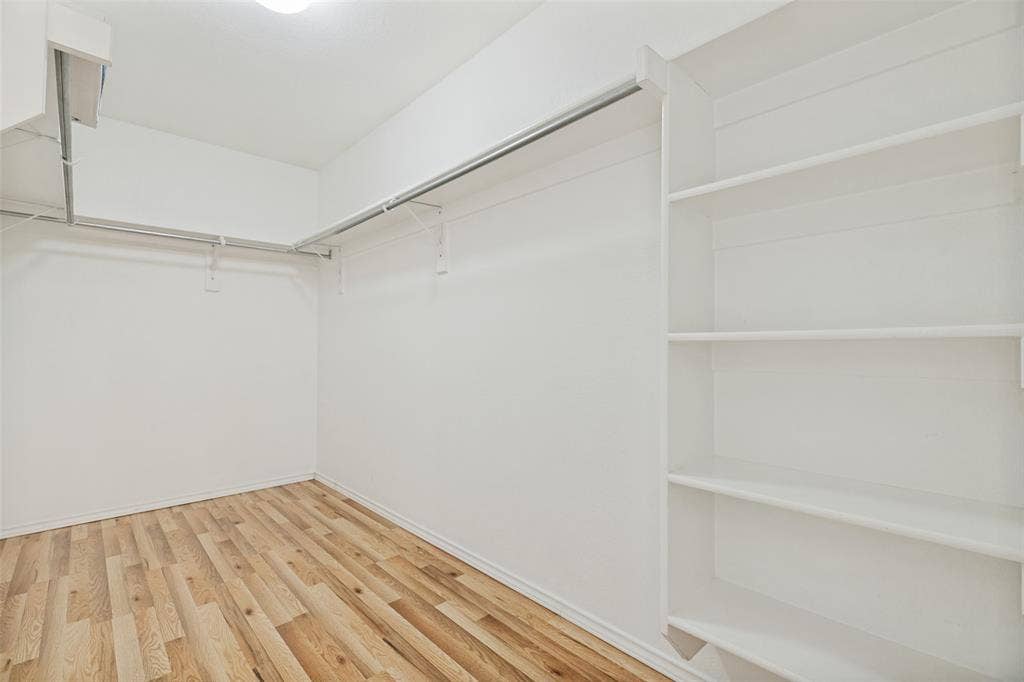 1412 Sleepy Hollow Drive, Allen, TX 75002 Wood-finish flooring, built-in shelving, white walls, and overhead lighting