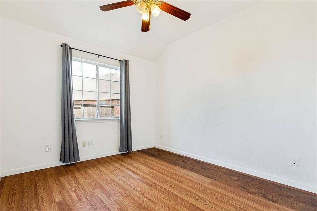 1412 Sleepy Hollow Drive, Allen, TX 75002 Wood-finish flooring, white walls, and a multi-pane window
