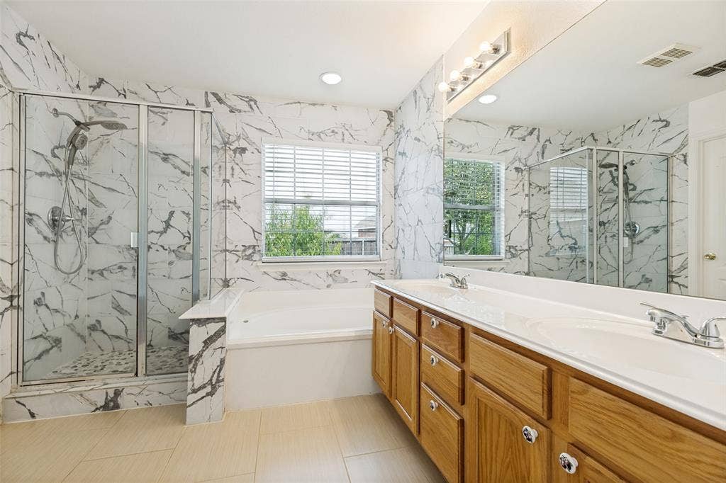 1412 Sleepy Hollow Drive, Allen, TX 75002 Spacious bathroom featuring a dual vanity, polished chrome fixtures, integrated soaking tub, and a separate glass-enclosed shower with a handheld spray