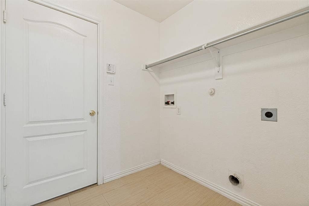 1412 Sleepy Hollow Drive, Allen, TX 75002 Laundry area with wood-finish flooring, built-in hanging rod, and utilities hookups