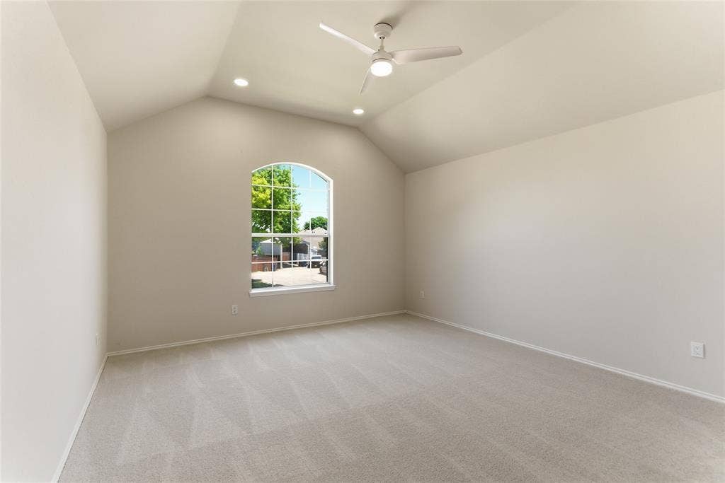 1416 Sunrise Lane, Sachse, TX 75048 Arched window, vaulted ceiling, flush-mount lighting, ceiling fan, and neutral carpet flooring