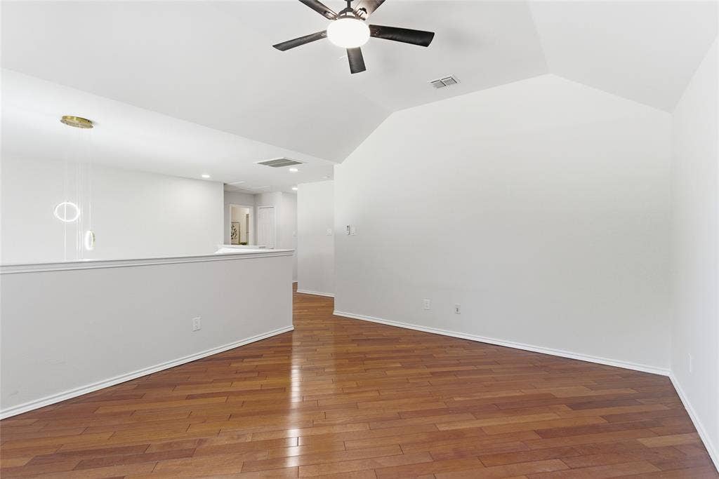 1416 Sunrise Lane, Sachse, TX 75048 Vaulted ceiling, wood-finish flooring, ceiling fan with light, modern pendant lighting, half-wall partition
