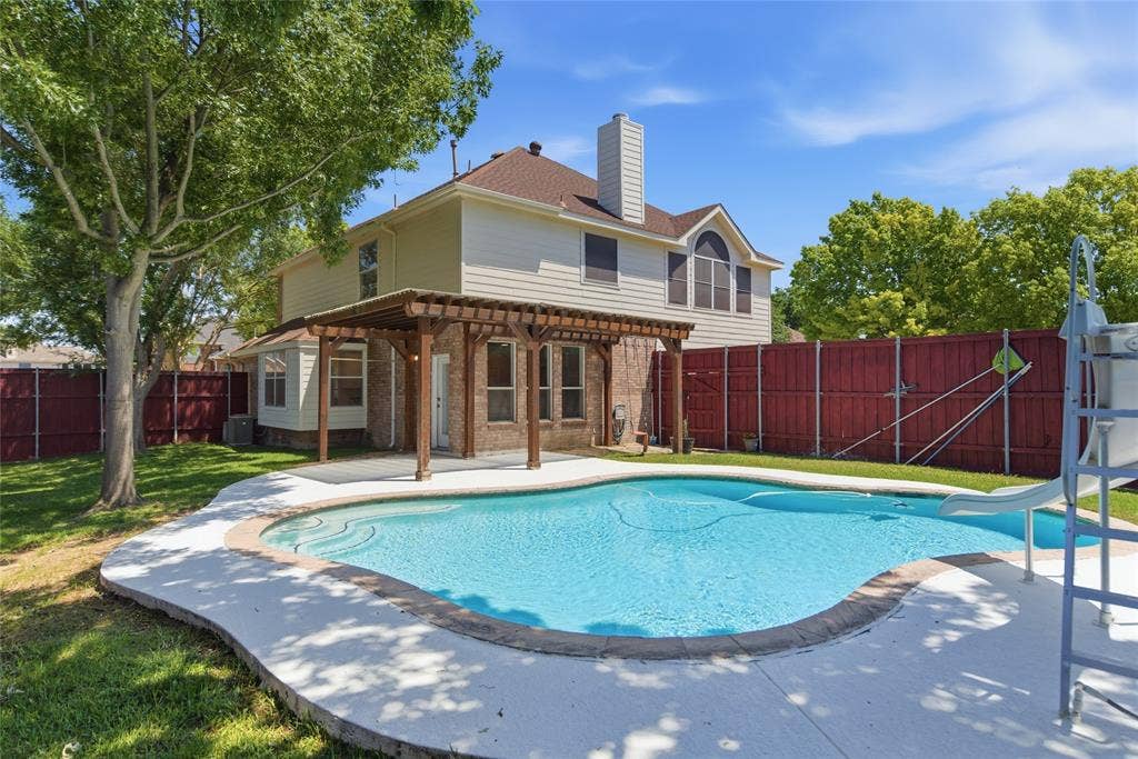 1416 Sunrise Lane, Sachse, TX 75048 Rear exterior featuring a swimming pool, concrete decking, and a wood pergola