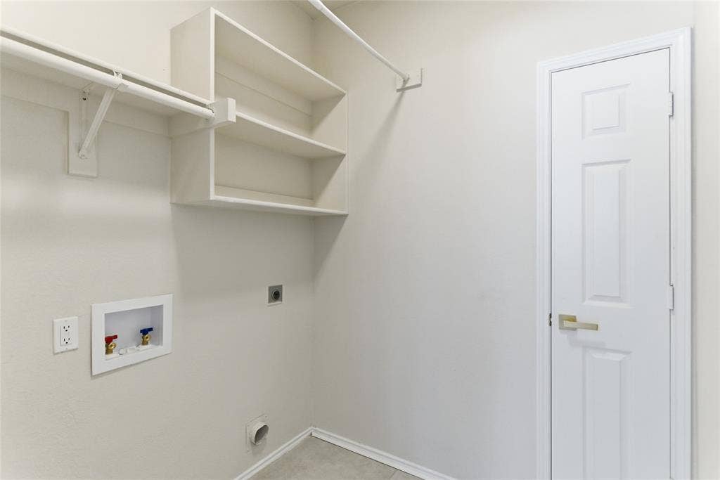 1416 Sunrise Lane, Sachse, TX 75048 Laundry area featuring built-in shelving, a clothes hanging rod, and utility hookups