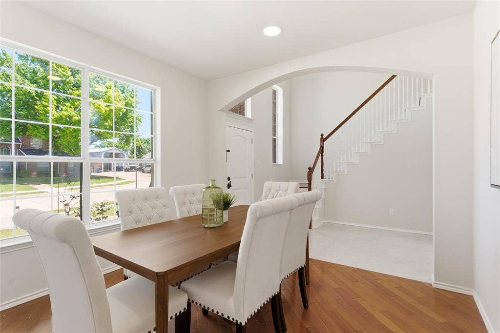 1416 Sunrise Lane, Sachse, TX 75048 Hardwood flooring, divided light window, arched doorway, recessed lighting, and a staircase with a wood handrail