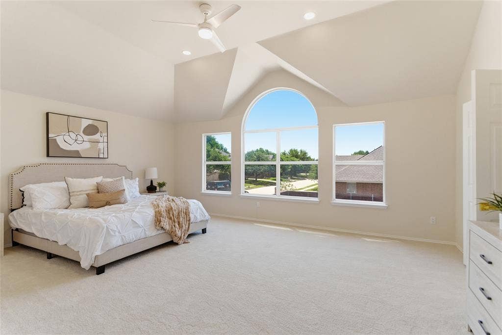 1416 Sunrise Lane, Sachse, TX 75048 Vaulted ceilings with recessed lighting, ceiling fan, arched window, and plush carpeting