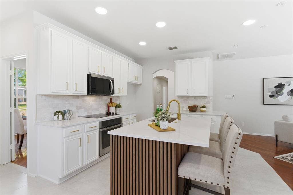 1416 Sunrise Lane, Sachse, TX 75048 White shaker-style cabinetry with gold-finish hardware, stainless steel appliances, and a tile backsplash