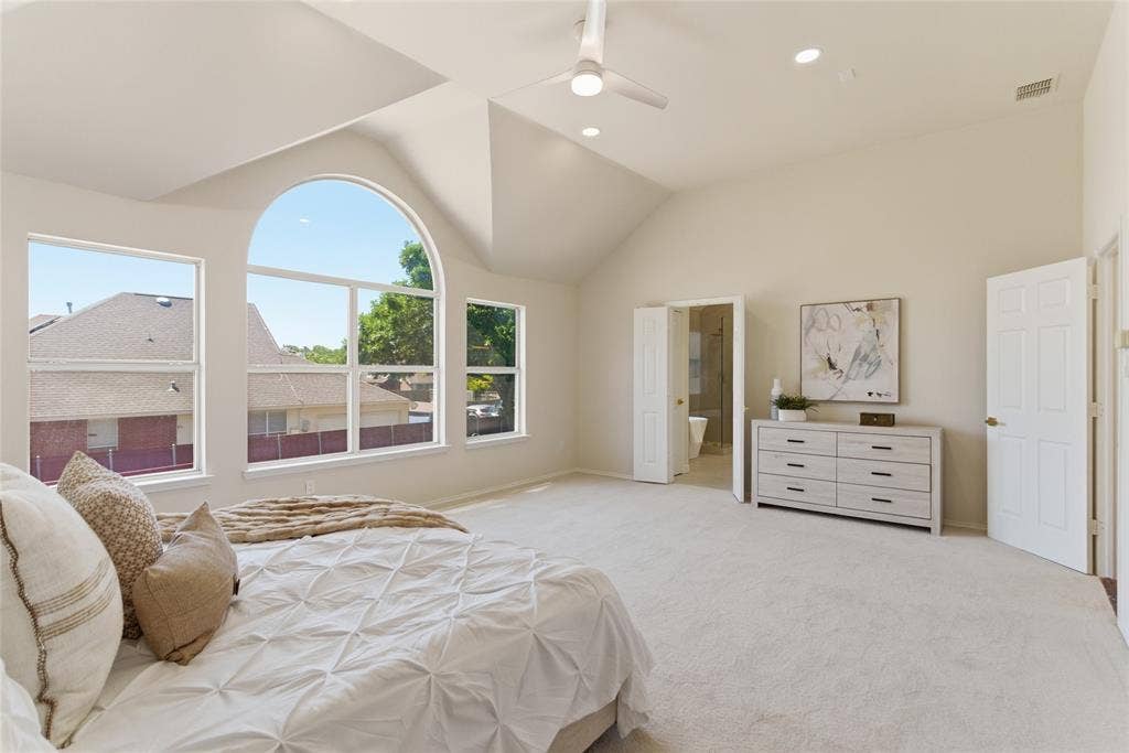 1416 Sunrise Lane, Sachse, TX 75048 Vaulted ceilings with recessed lighting, large arched window, multiple windows, ceiling fan, and light-colored carpeting