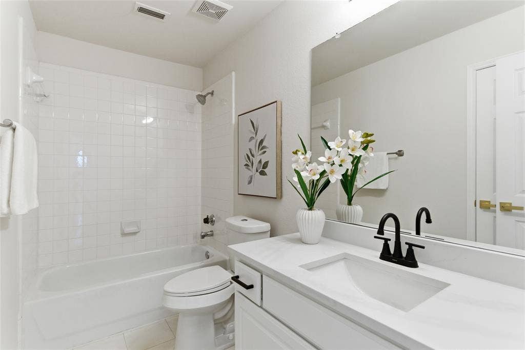 1416 Sunrise Lane, Sachse, TX 75048 White vanity with an integrated rectangular sink, matte black faucet, and large wall-mounted mirror