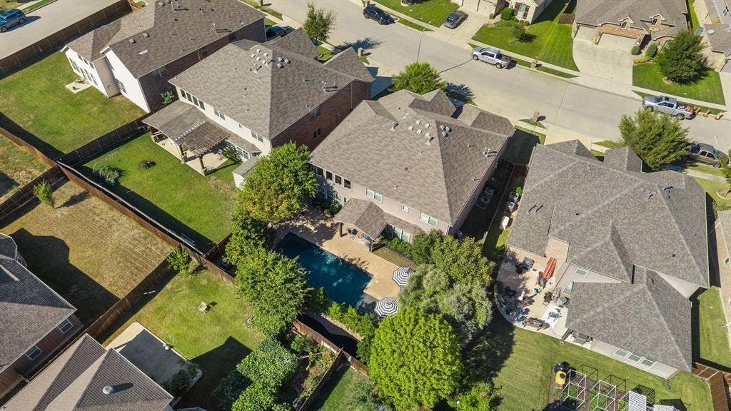 1049 Mesa Crest Drive, Fort Worth, TX 76052 Expansive backyard featuring a swimming pool, paved patio, and mature trees