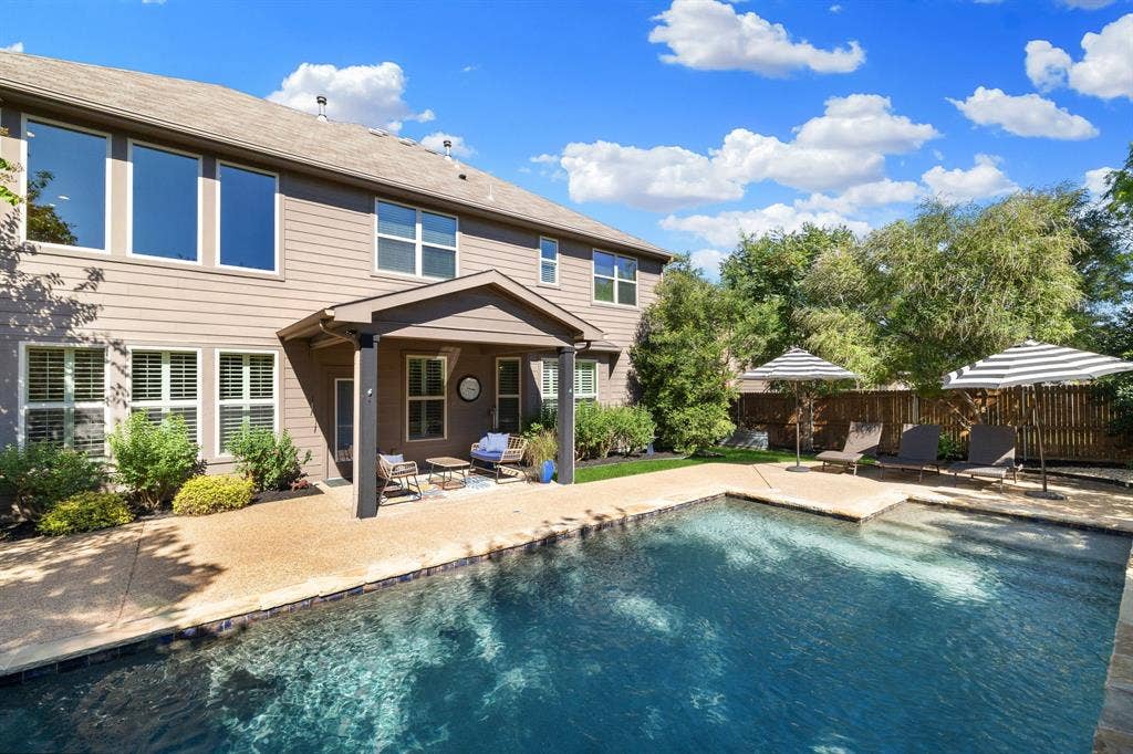 1049 Mesa Crest Drive, Fort Worth, TX 76052 Expansive inground swimming pool with integrated steps, surrounded by a concrete patio