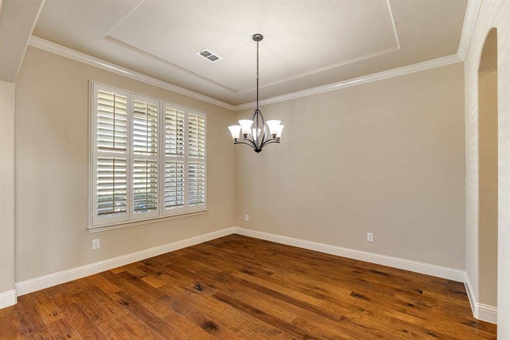 1049 Mesa Crest Drive, Fort Worth, TX 76052 Formal Dining with Wood-finish flooring, plantation shutters, tray ceiling, and a five-light chandelier