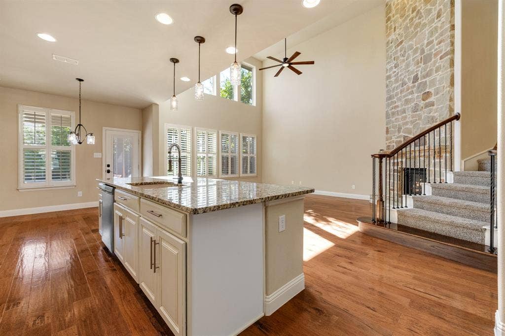 1049 Mesa Crest Drive, Fort Worth, TX 76052 Kitchen island with a granite countertop, undermount sink, and pendant lighting