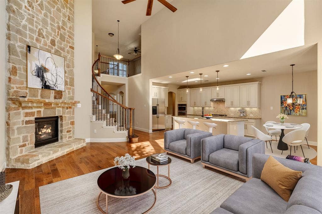 1049 Mesa Crest Drive, Fort Worth, TX 76052 Two-story living area featuring a stone-clad fireplace and wood-finish flooring