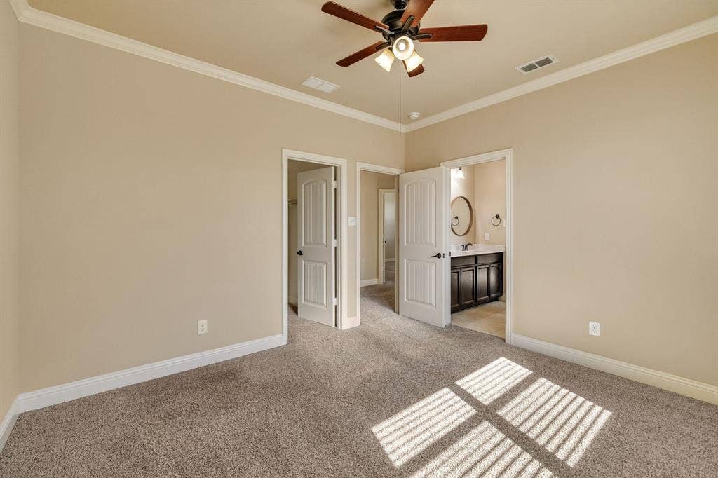 1049 Mesa Crest Drive, Fort Worth, TX 76052 Carpeted room with crown molding, ceiling fan, and white doors