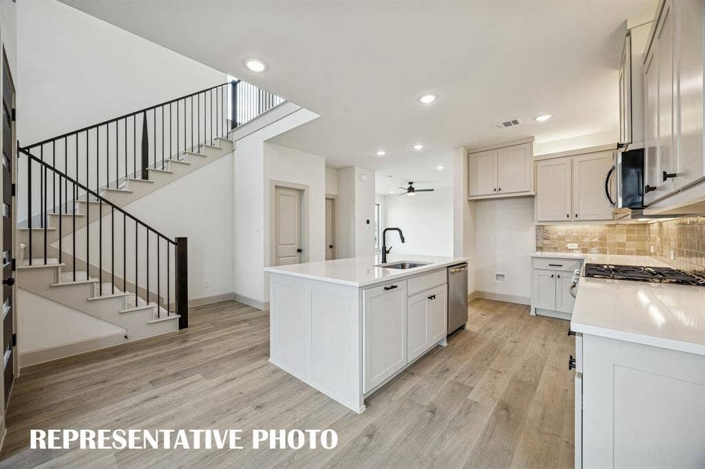 3729 Homer Court, McKinney, TX 75071 Beautiful cabinetry, gorgeous counter tops and contemporary railings create a contemporary dream kitchen! REPRESENTATIVE PHOTO