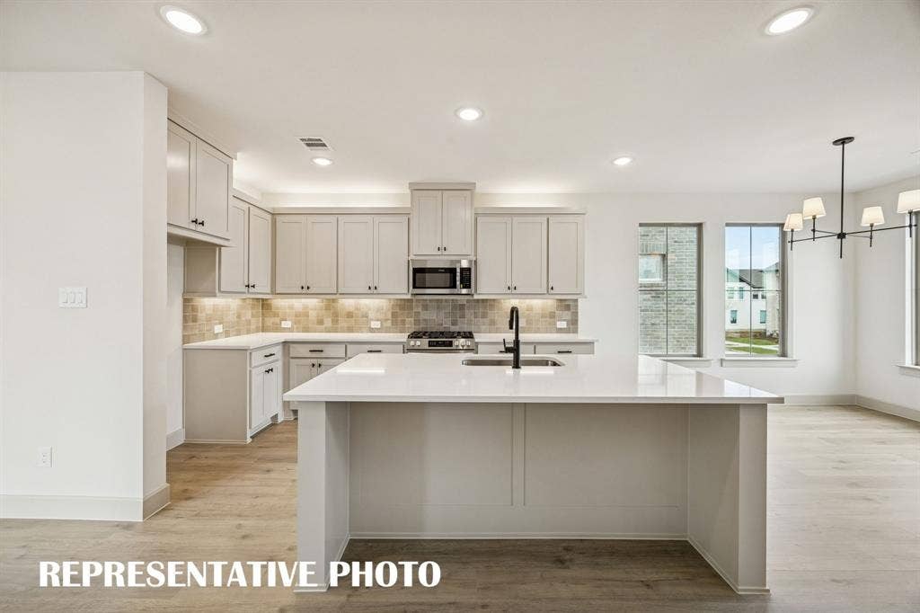 3729 Homer Court, McKinney, TX 75071 This dream home features a spacious kitchen island where friends and family are sure to gather round! REPRESENTATIVE PHOTO