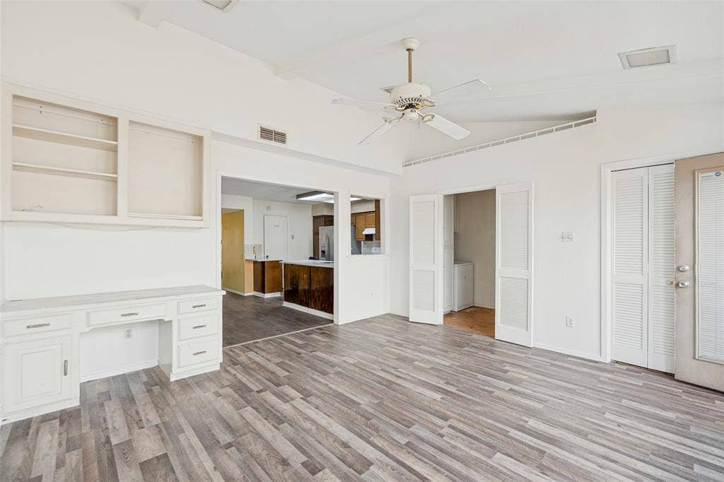11916 Leisure Drive, Dallas, TX 75243 Wood-finish flooring, built-in desk with overhead shelving, vaulted ceiling, and ceiling fan