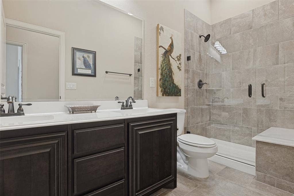 Hall bath with dual sings and walk in shower with seat.