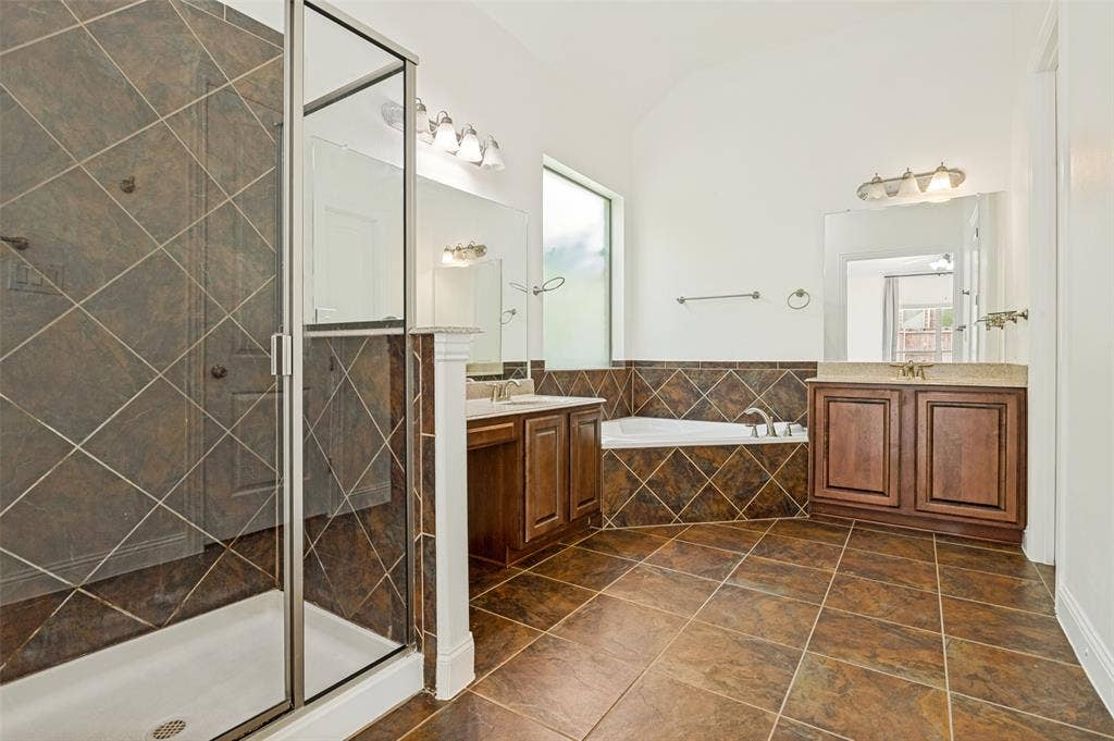 6734 Trailblazer Way, Dallas, TX 75236 Glass-enclosed shower, built-in soaking tub, dual vanity with undermount sinks, tile flooring, and vaulted ceiling