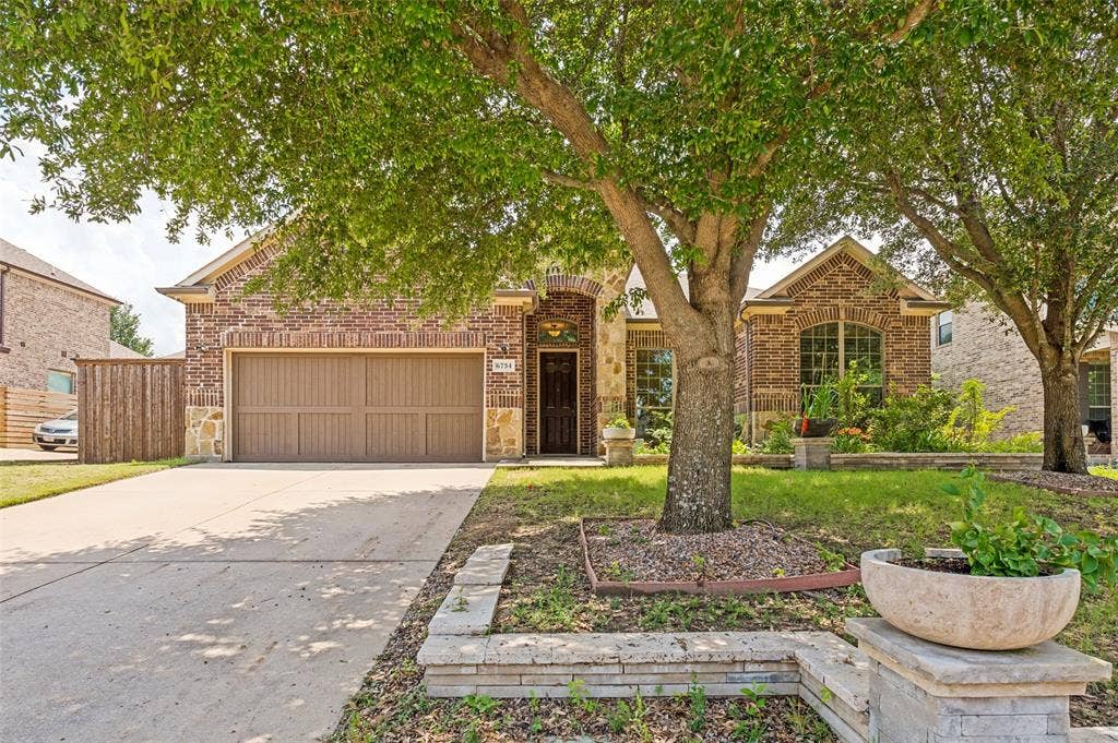 6734 Trailblazer Way, Dallas, TX 75236 Brick and stone exterior with arched entry