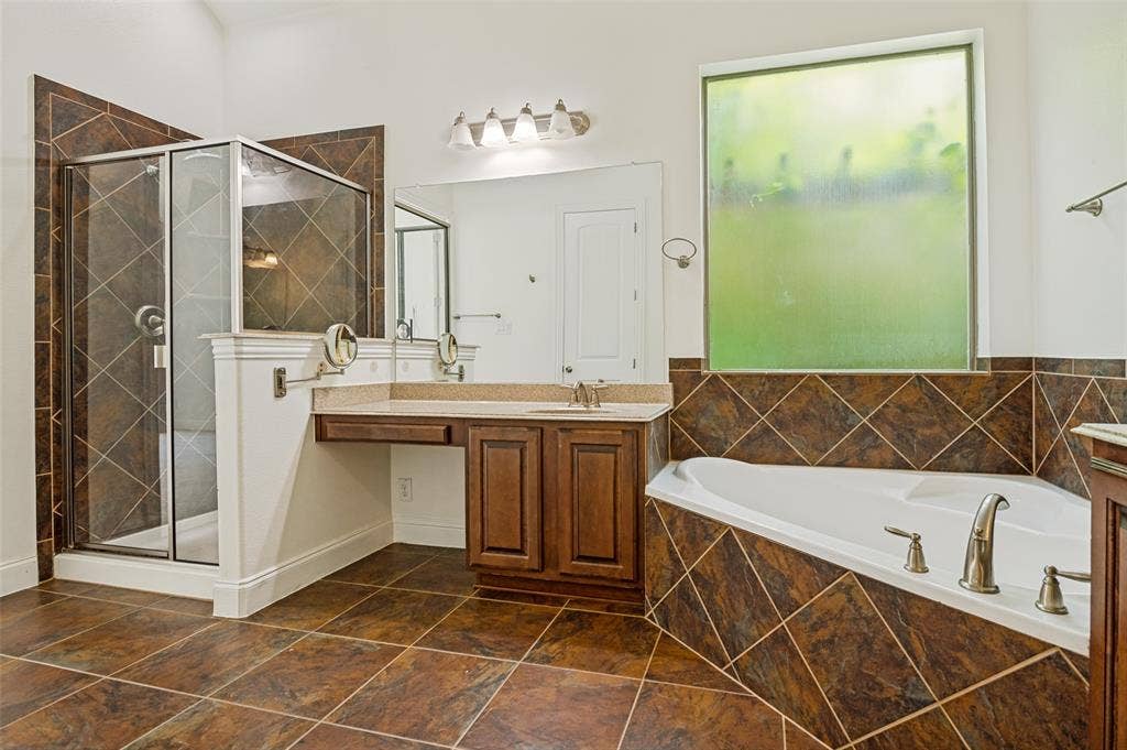 6734 Trailblazer Way, Dallas, TX 75236 Tiled flooring, glass-enclosed shower, dual vanity with granite-style countertop, built-in soaking tub, and privacy window