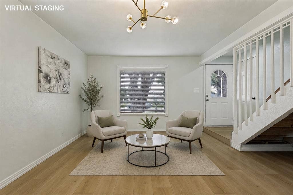 2018 Vail Drive, Garland, TX 75044 Hardwood-finish flooring, staircase with white balusters, transom window above the entry door, and a contemporary light fixture