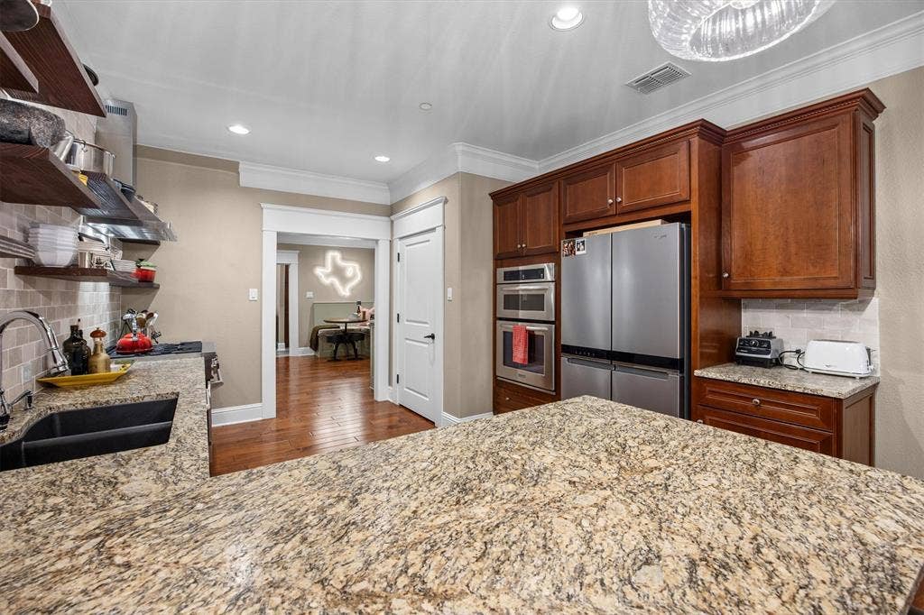 Premium leathered granite countertops, upgraded appliance suite with custom recessed refrigerator profile. Convection microwave and built in 2nd oven.