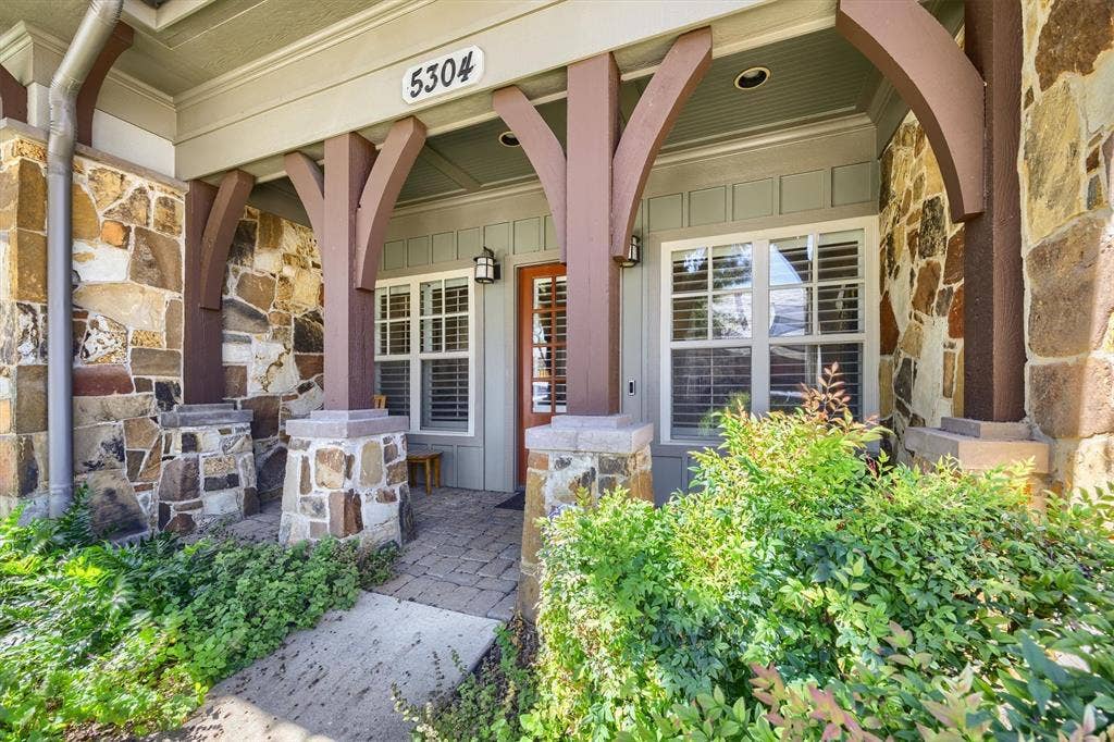 Handsome front porch, featuring stone and wood columns. Hard wired cameras add extra security.