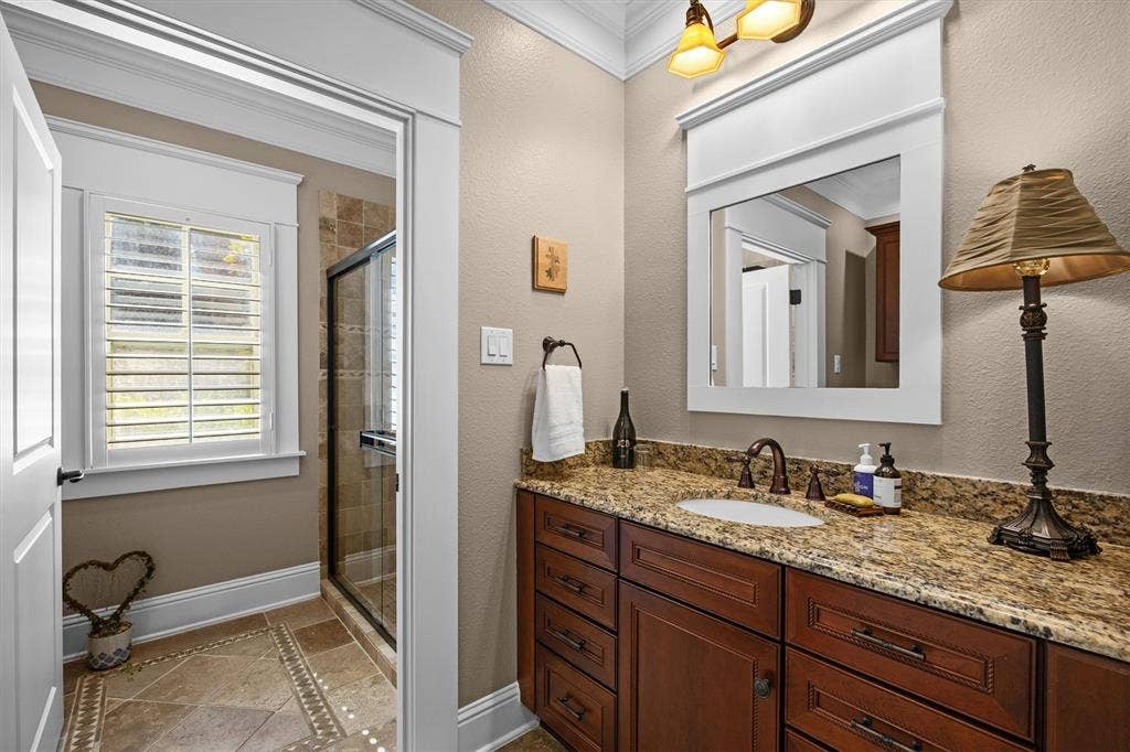 Guest bathroom with separate tub and shower along with tons of cabinet and counter space.