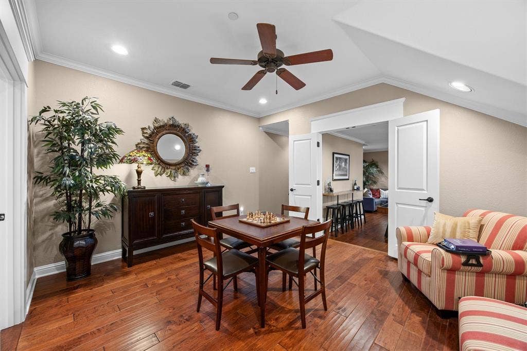 Hardwood flooring extends into step down game room.
