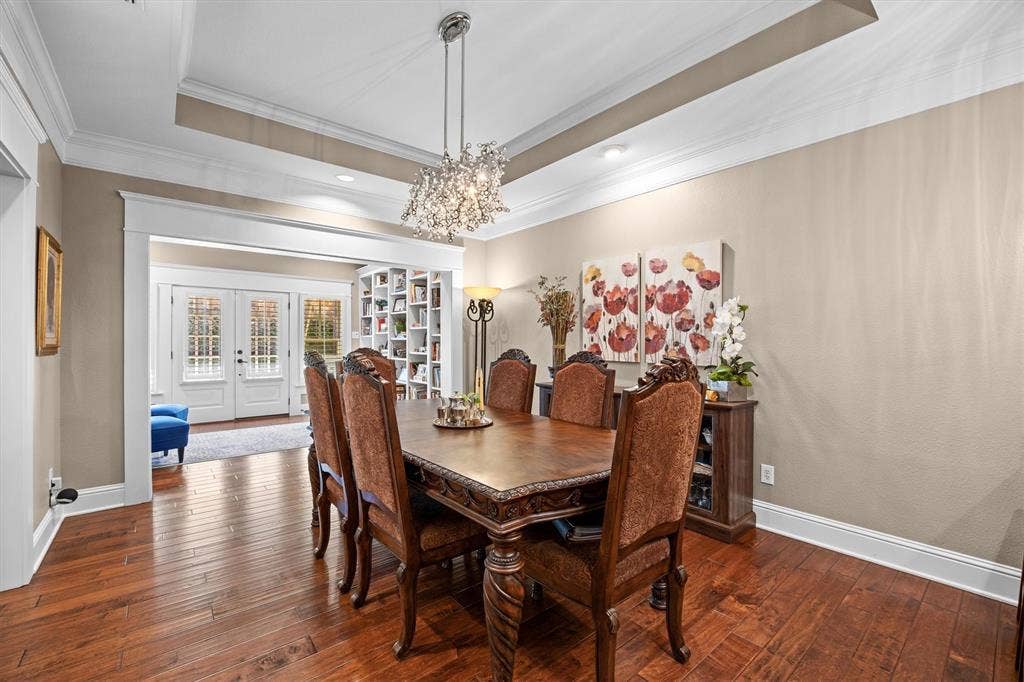 Formal dining area right off of the kitchen and living room is a focal point! Stunning light fixture and tray ceiling gives balance and highlights this perfect place for family gatherings.