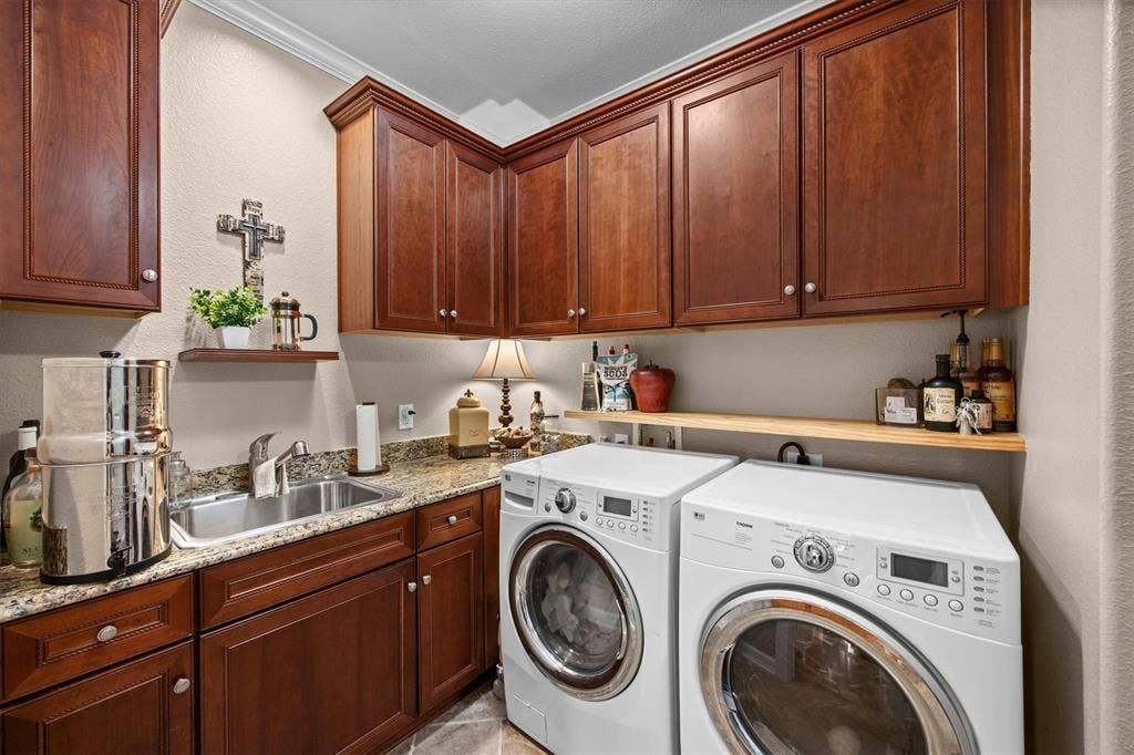 Laundry conveniently located with additional storage as well as sink and countertops!