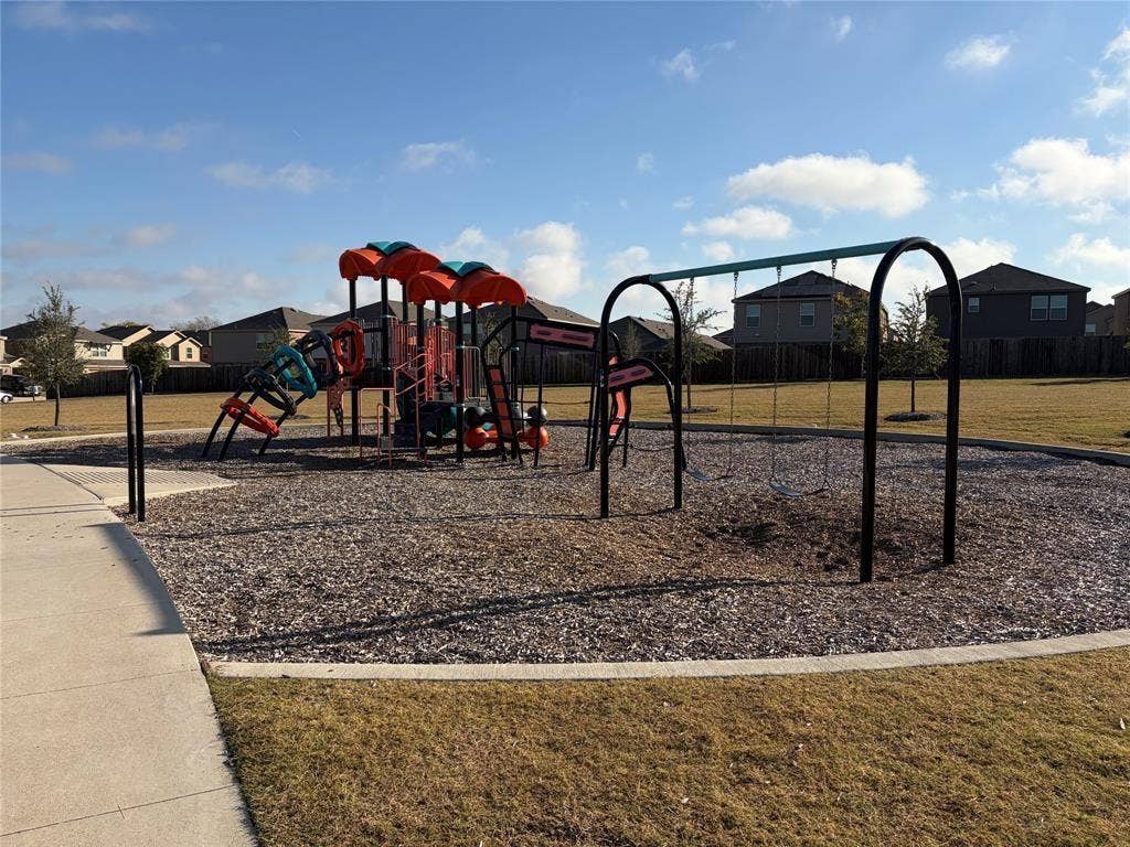 845 Poppy Cove Lane, Princeton, TX 75407 Community playground featuring a multi-level play structure, swing set, and wood chip surfacing