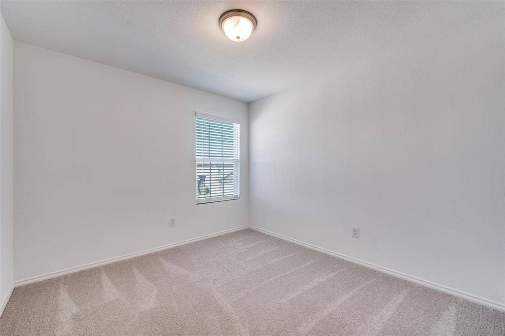845 Poppy Cove Lane, Princeton, TX 75407 Neutral paint palette, single window with blinds, carpeted flooring, and ceiling-mounted light fixture