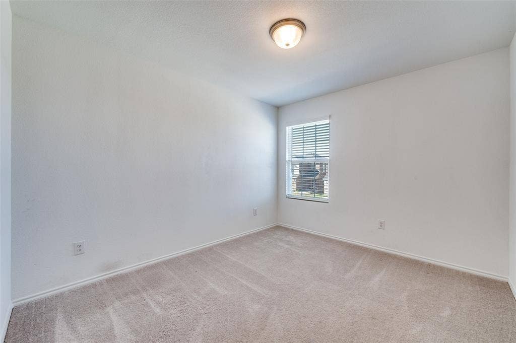 845 Poppy Cove Lane, Princeton, TX 75407 Carpeted room featuring a single window with blinds and a ceiling-mounted light fixture